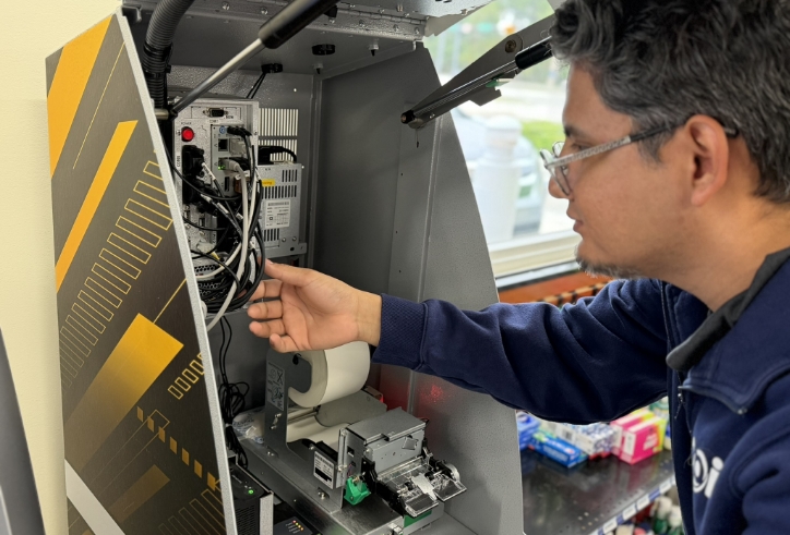 An eingineer working on an ATM